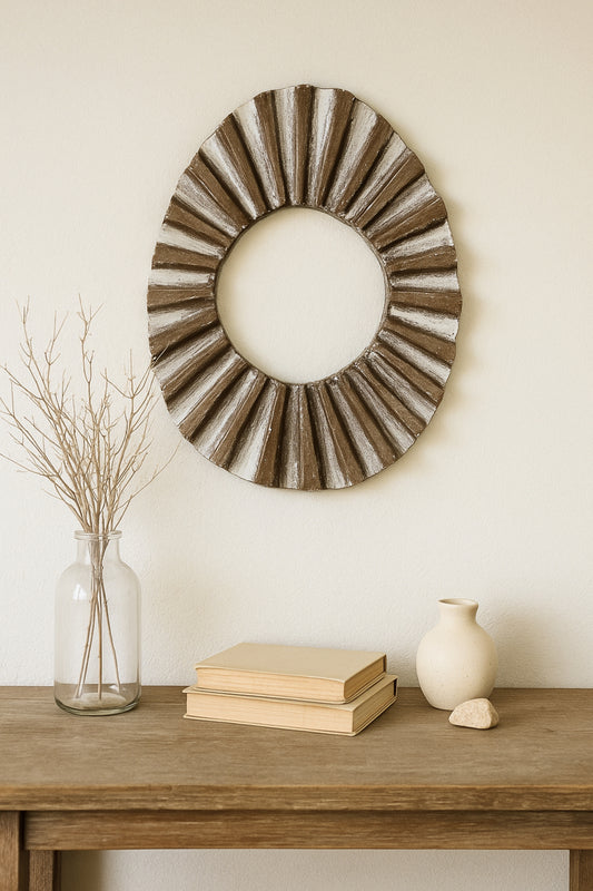 Wall sculpture styled above a console with neutral ceramics in a japandi living space