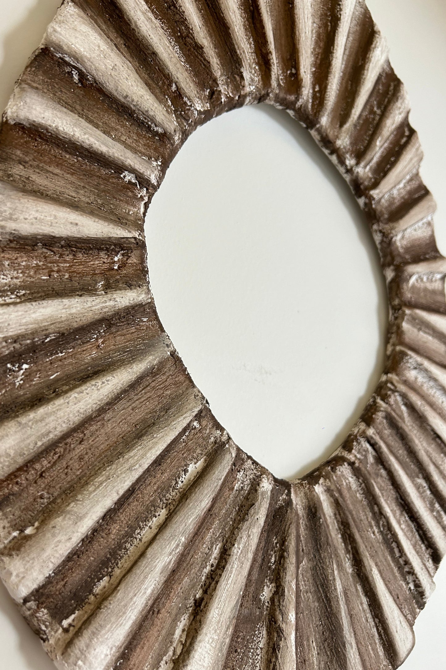Top view of organic oval wall decor capturing natural ridges