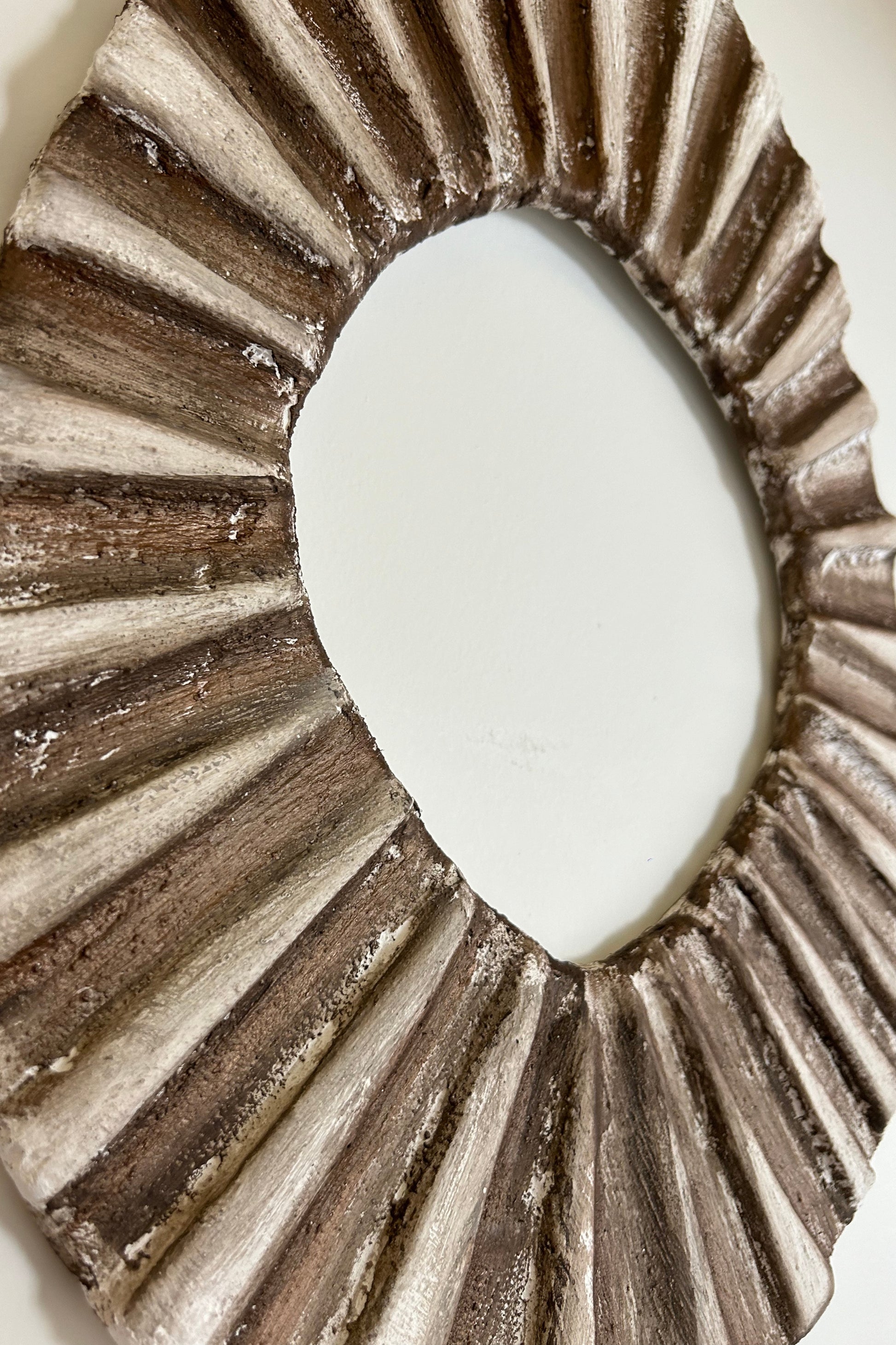 Top view of organic oval wall decor capturing natural ridges