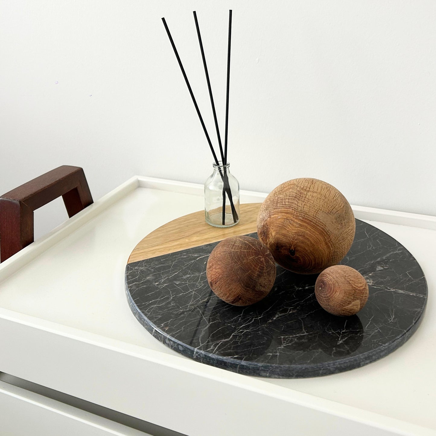  Minimalist corner styling using a handmade wooden ball set and simple ceramic accents.