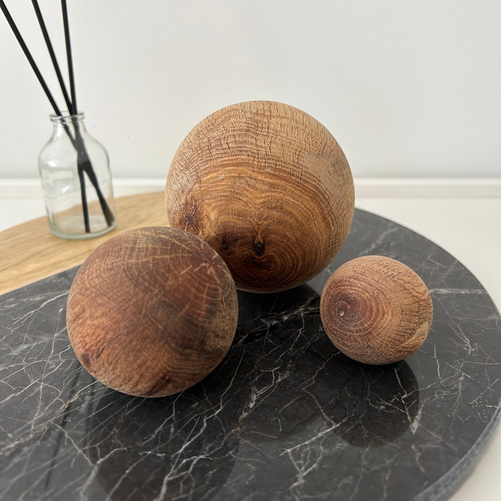 Rustic wooden sphere set including large, medium, and small sizes placed for table styling.